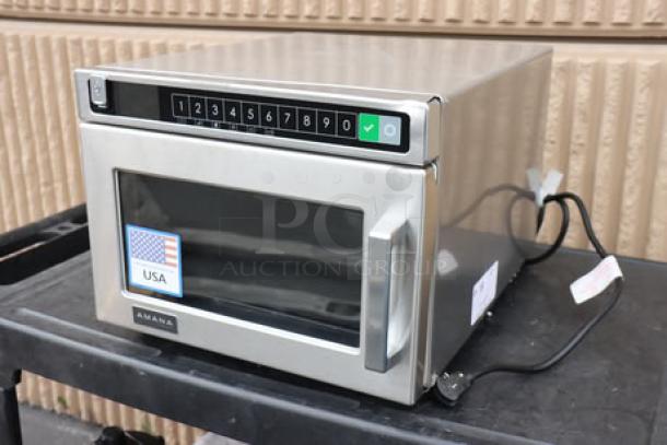 Brand new Amana HDC12A2 commercial microwave, 1200W, stainless steel, minor dent top right, door slightly misaligned.