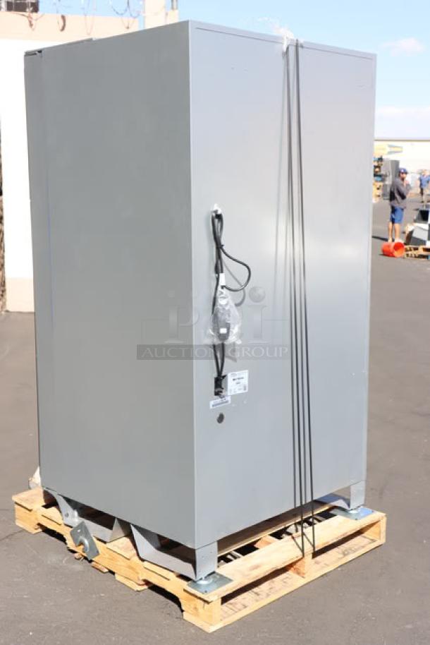 Seaga ENV5S vending machine on a pallet, side view. Brand new, front glass shattered. 115 volts, 4 amps, 1 phase.