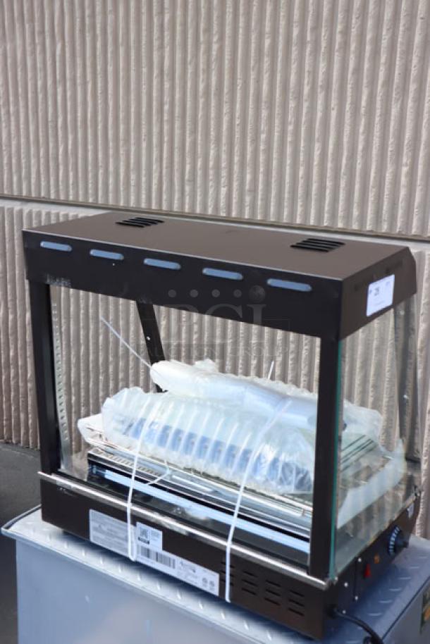 Brand new Avantco HDC-26 heated display case, 3 shelves, scratch-n-dent, 26", sliding doors, 1580W, tags visible.