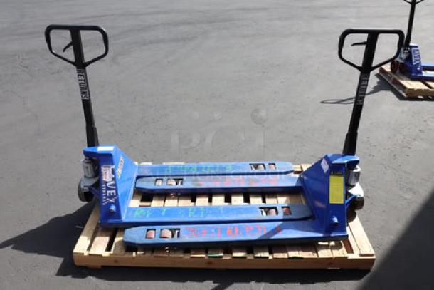 Pair of Lavex pallet jacks on wooden pallet. Blue metal, sturdy handles, visible markings. Used condition.
