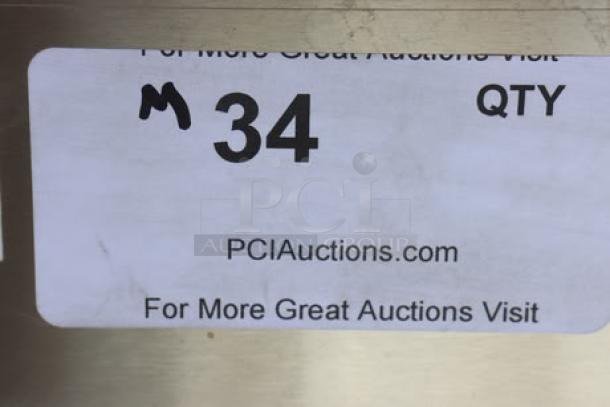 Sticker label reading "M 34 QTY," with URL "PCIAuctions.com" and promotional text.