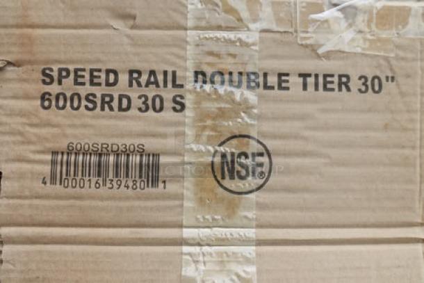 Cardboard box showing torn packaging of Regency Spec Line 600SRD30S 30" stainless steel double tier speed rail, NSF marked.