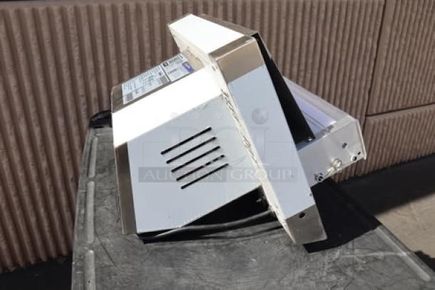 Brand new Estella EDS12S countertop dough sheeter, 12", 120V, 1/2 HP, with visible minor scratches and dents. Model and serial details on label.