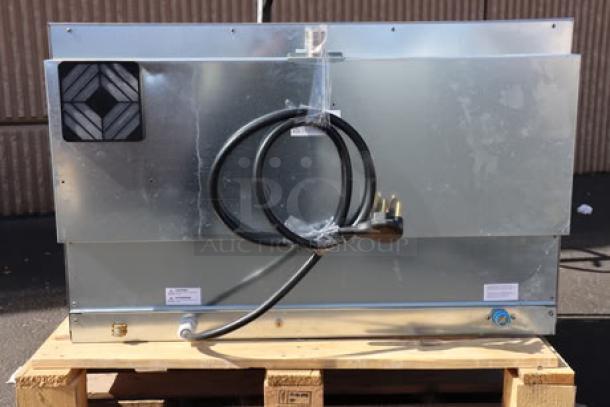 Cooking Performance Group COF-T4-M convection oven back view, showing power cord and metal casing. Model and serial number tags visible.