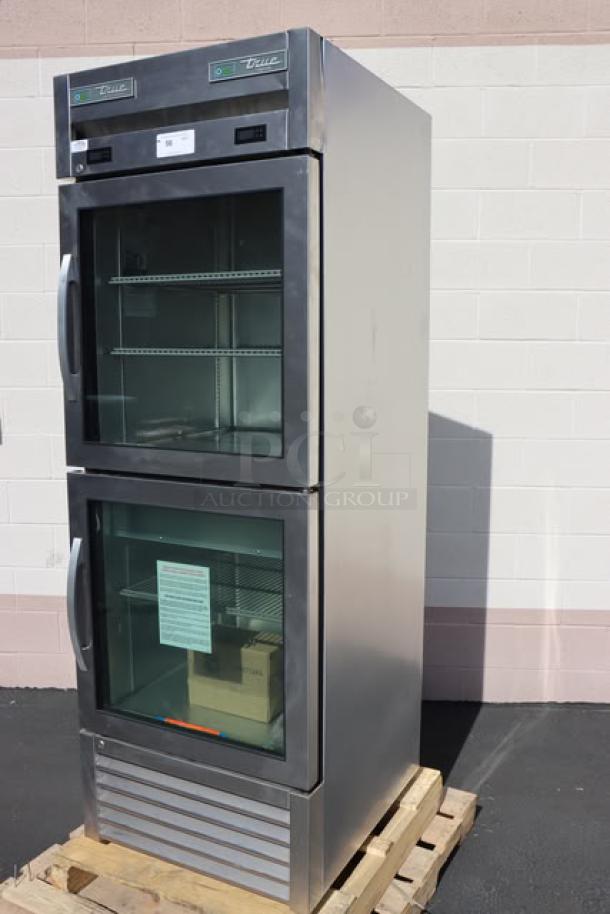BRAND NEW True T-23DT-G-HC~FGD01 27" glass half door reach-in fridge/freezer on a pallet. Minor scuffs. Includes adjustable shelves.