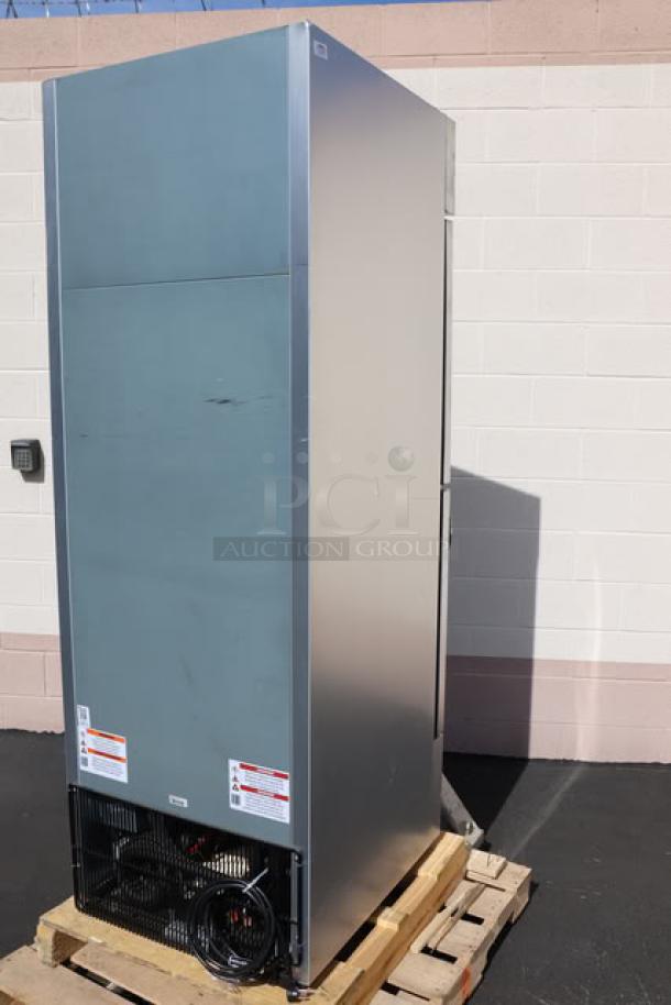 True T-23DT-G-HC~FGD01 27" glass half-door reach-in combination refrigerator/freezer on a pallet, minor scuffs visible.