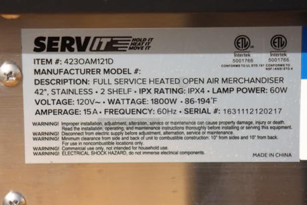 "ServIt OAM-121D label showing specs: 42" slanted 2-shelf, 1860W, 120V, IPX4, Serial 1631112120217, made in China."