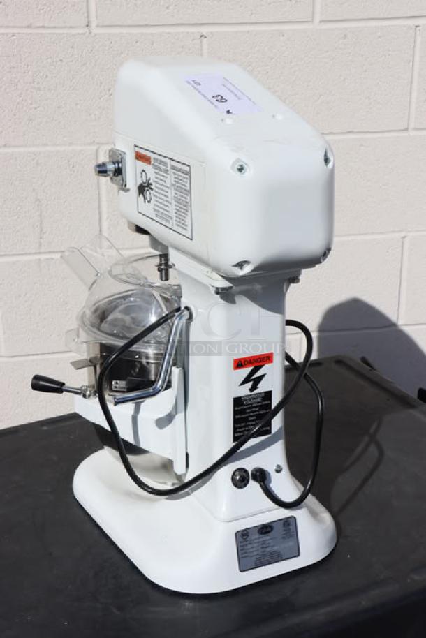 Brand new Globe SP08 8 Qt. countertop mixer, bowl lift design, safety guard, 120V, 5 Amps, model tags visible.