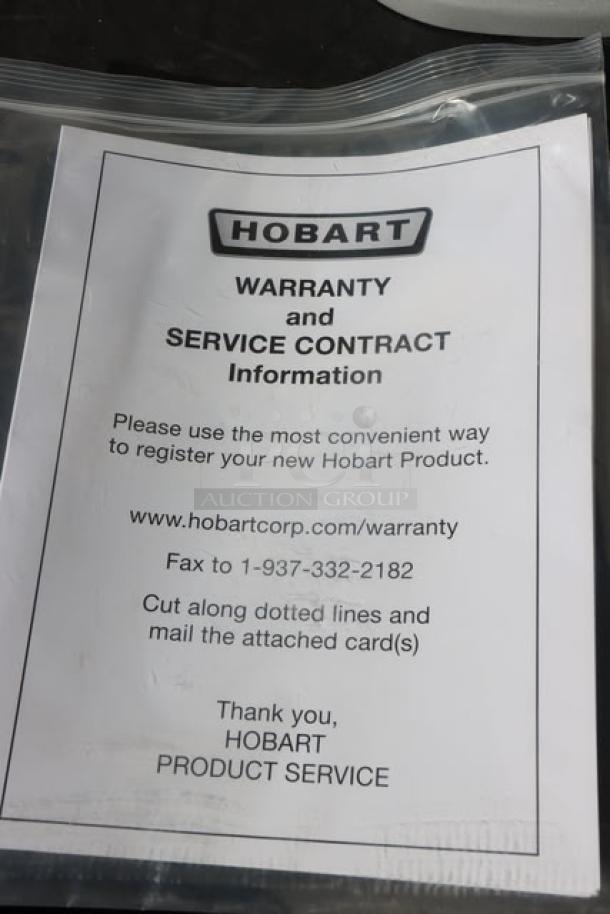 Hobart warranty and service contract information sheet in a plastic bag. Includes registration and contact details.