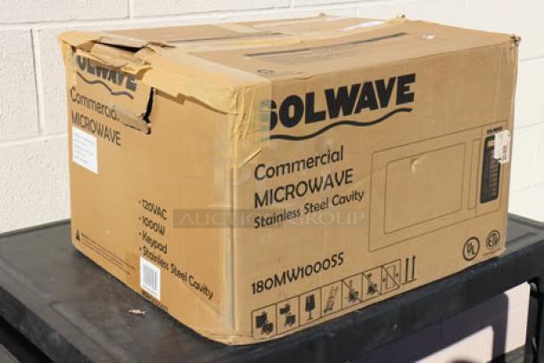Brand new Solwave EM025FJT-S0SA00 commercial microwave in box; stainless steel, push button controls, 1,000W, 120V. Box slightly damaged.