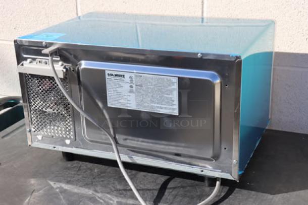 Brand new Solwave EM025FJT-S0SA00 commercial microwave, stainless steel, 120V, 8.3A, 1 phase, 1000W, with labels detailed.