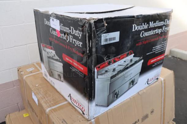 Brand new Avantco F202 dual tank electric fryer, 30 lb, 208-240V, in damaged packaging. Model visible; may have scratches.