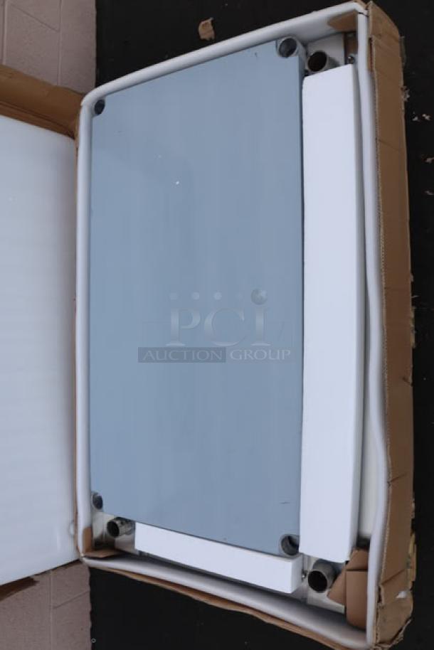 Brand new Regency Spec Line ESS-3048-314 stainless steel equipment stand, 30" x 48", with undershelf. Damaged packaging.