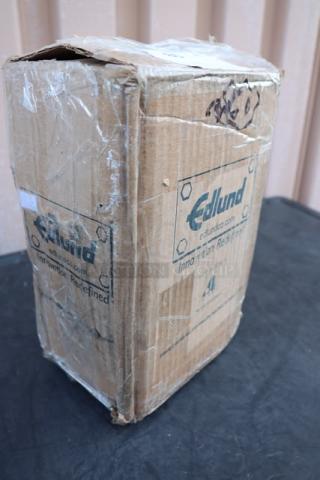 Brand new Edlund 203 electric can opener in damaged original packaging. S/N: 111749, 115V, two-speed, tabletop model.