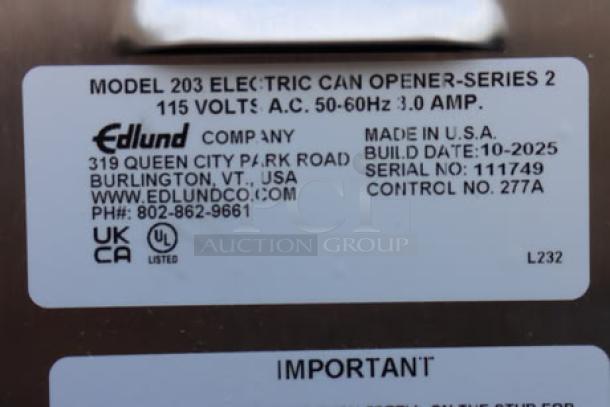 Edlund 203 Two-Speed Electric Can Opener label showing model, voltage, serial number 111749, and manufacture details. Original packaging damaged.