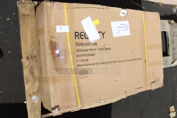 Regency 30" x 48" stainless steel work table, model 600TSB3048S, in damaged packaging; table may have minor scuffs/dings.