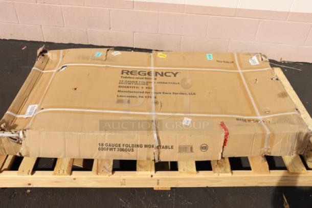 New Regency FWT-3060-US-418 30"x60" stainless steel folding work table in damaged original packaging, 18-gauge, with removable undershelf.