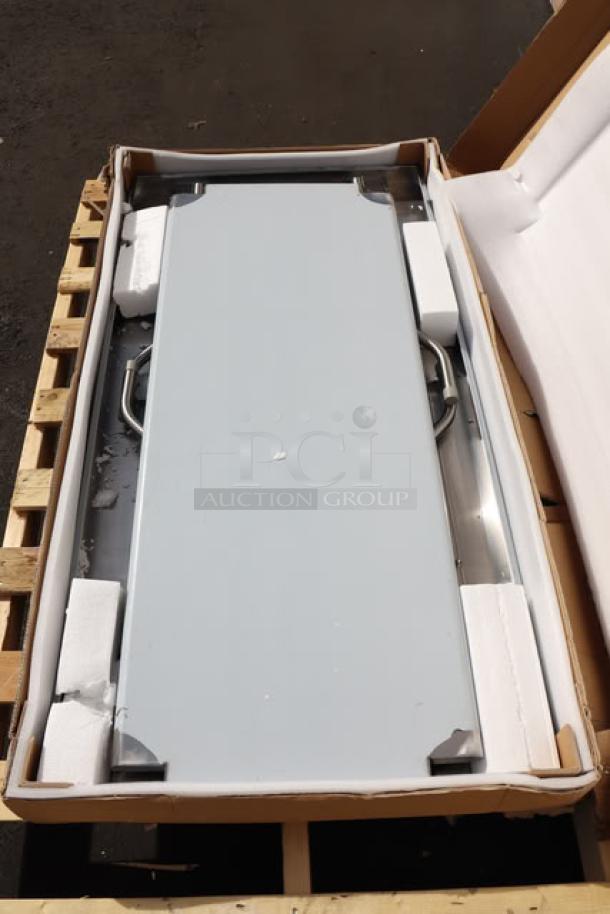 Brand new Regency FWT-3060-US-418 30"x60" stainless steel folding work table with removable undershelf, in damaged packaging.