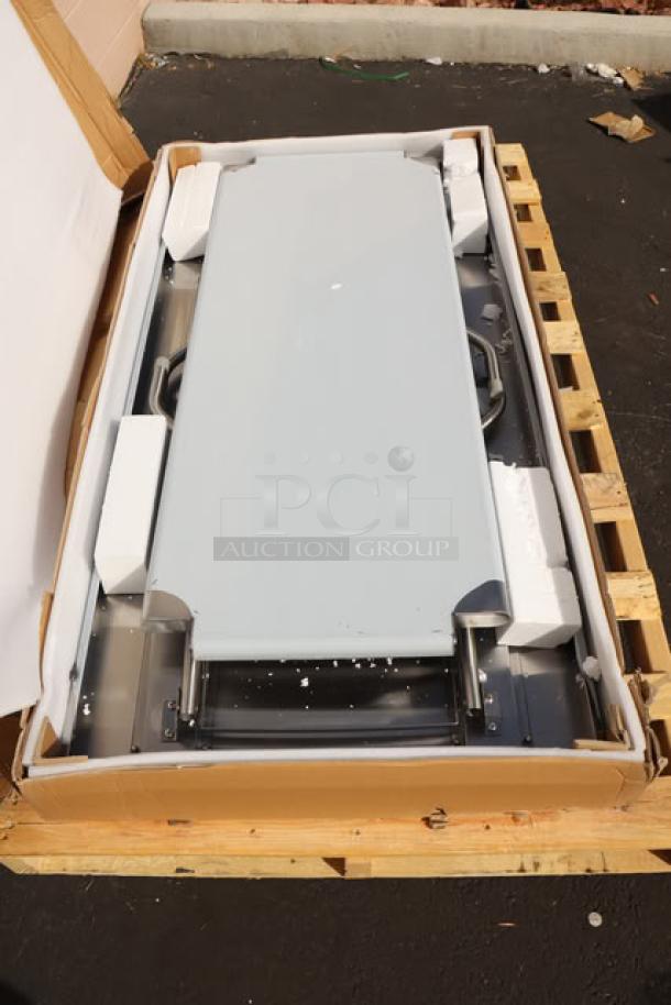 Brand new Regency FWT-3060-US-418, 30"x60" stainless steel folding work table with removable undershelf, in original damaged packaging.