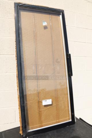 Replacement glass door for refrigerator/freezer, black frame, new condition, protective packaging intact, visible handle.