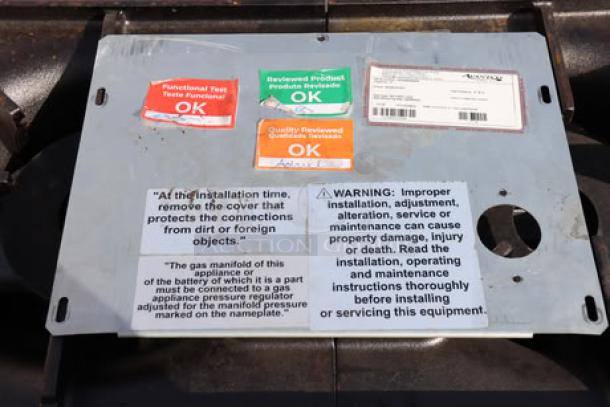 Brand new Avantco Chef Series CAG-R-2-12 gas range, 12" 2-burner, 50,000 BTU. Tags show functional test and safety warnings.