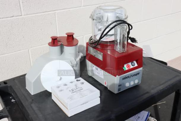 BRAND NEW Robot Coupe R2NCLR food processor, 1 hp, clear bowl, continuous feed, 2 discs; scratch-n-dent, unpackaged.