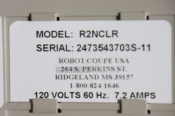 Robot Coupe R2NCLR label showing model, serial number 2473543703S-11, voltage, address, and contact information.