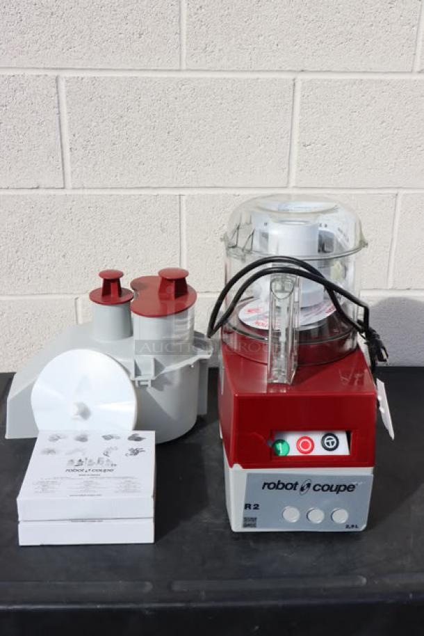 Brand new Robot Coupe R2NCLR food processor, 3 Qt. clear bowl, continuous feed, 2 discs, 1 hp, tags attached. No box.
