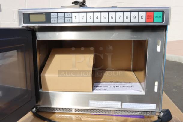 Brand new Panasonic NE-21523 stainless steel commercial microwave oven, 208/240V, 2100W, with open door showing interior packaging.