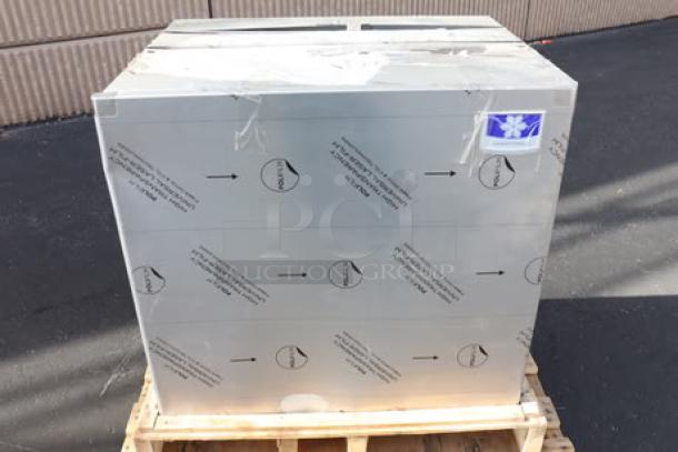 Brand new Manitowoc air-cooled ice machine, mint condition, scratch-n-dent marked, packaged on a wooden pallet.