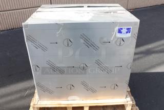 Brand new Manitowoc air-cooled ice machine, mint condition, scratch-n-dent marked, packaged on a wooden pallet.