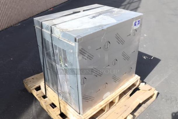 BRAND NEW SCRATCH-N-DENT Manitowoc Air Cooled Ice Machine on pallet, visible protective wrapping, minor exterior scratches.