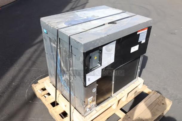 Brand new Manitowoc air-cooled ice machine with minor scratches and dents. Still strapped on a pallet. Labels intact.