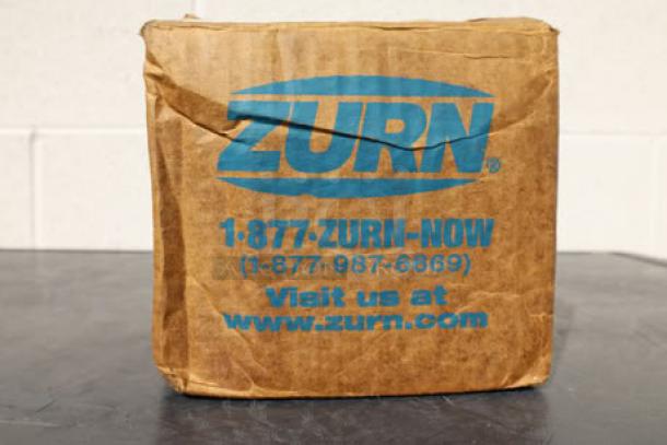 Brown box featuring the Zurn logo, contact information, and website. Contains a Zurn Elkay ZN400-6B strainer, brand new.