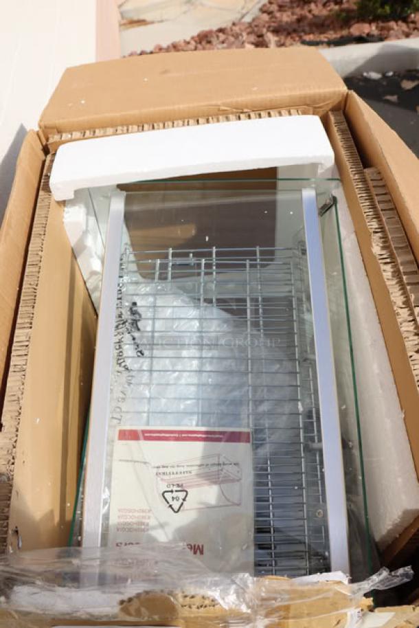 Brand new Carnival King HDCG2A hot food display case, silver, curved glass, 2 shelves, 120V, 800W; packaging damaged.
