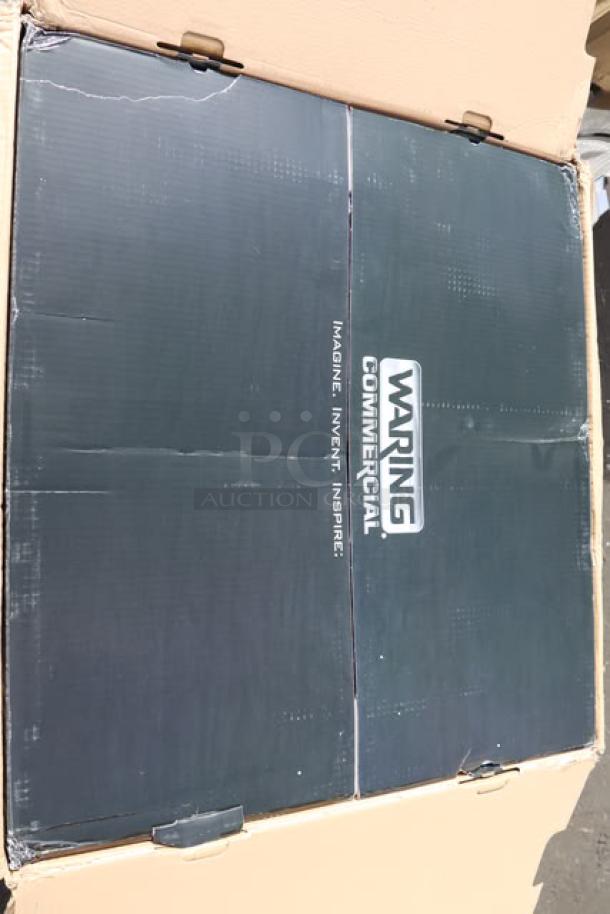 Brand new Waring WCO500X convection oven in damaged packaging; half-size, 120V, 1700W, model visible on box.