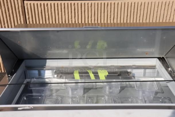 Beverage-Air SPED72HC-30M-2 72" refrigerated prep table with open top, showing compartments. Clean and well-maintained.