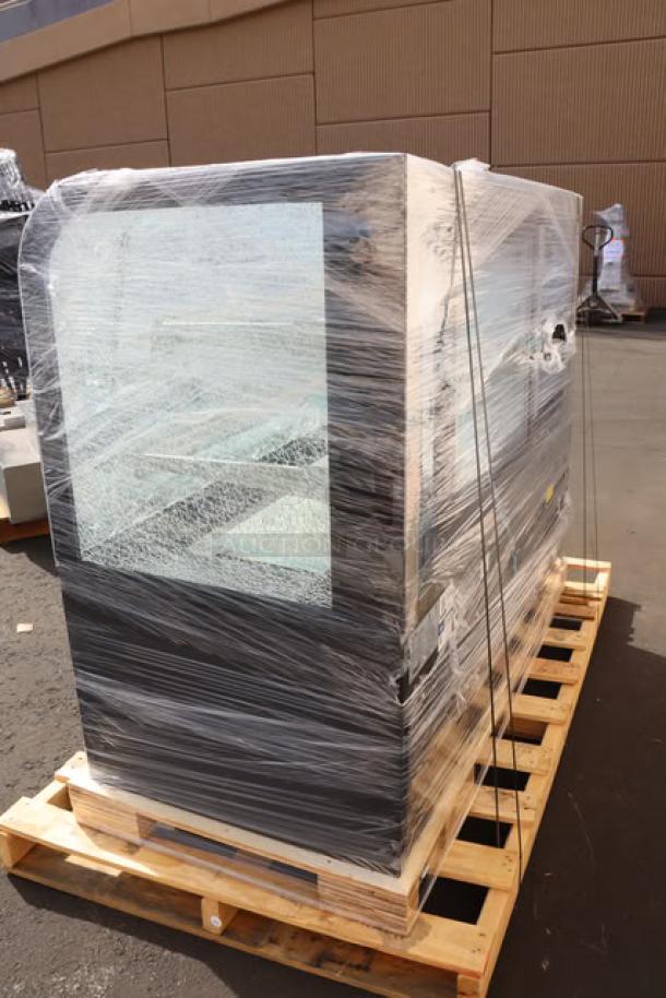Brand new Avantco BC-60-HC bakery display case on pallet. Curved glass is broken. Wrapped in plastic. Model BC-60-HC-30M-2.