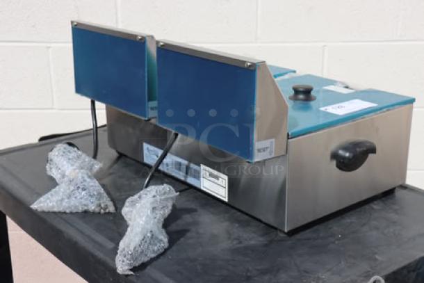 Brand new Avantco F102 20 lb. dual tank electric fryer, 120V, 3500W. Unit out of packaging, model label visible.