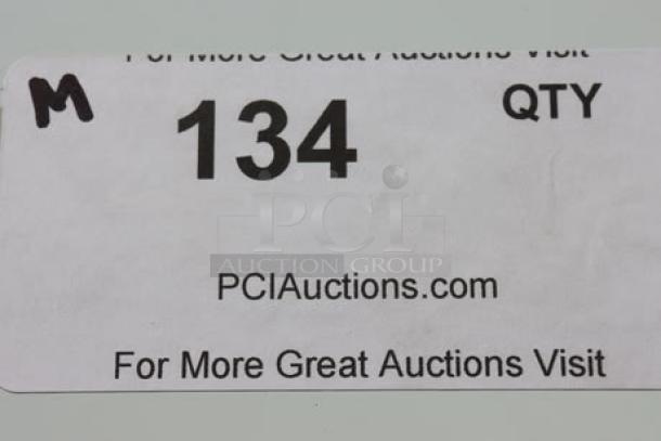Barcode label with text "134 QTY," website "PCIAuctions.com," and the letter "M" handwritten in the corner.
