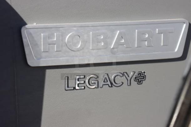 Hobart Legacy+ HL200-10STD 20 Qt. mixer in near-perfect condition; minor scratches and dents; brand logo visible.