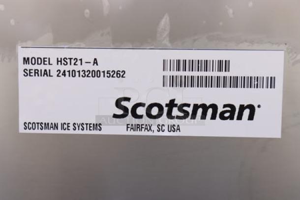 Stainless steel Scotsman HST21-A ice dispenser stand with door, dented on top back right. Serial: 24101320015262. Brand label visible.
