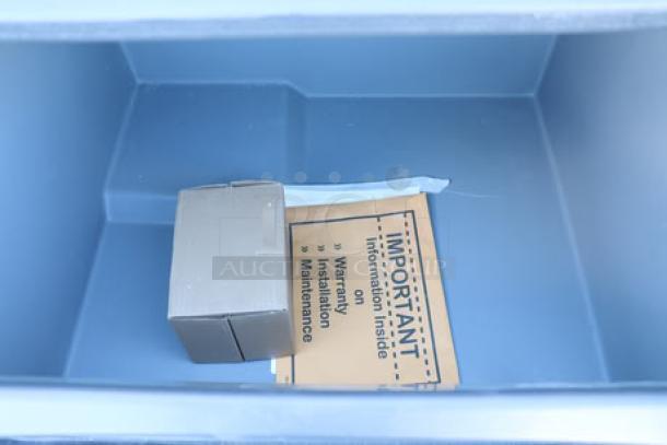 Brand new Scotsman CU3030MA-1 ice machine with minor dents, includes adjustable legs and scoop. Manual inside.