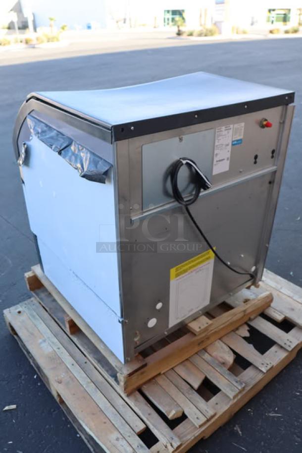 Brand new Scotsman CU3030MA-1 ice machine, minor dents, 313 lbs capacity, with labels, 6" adjustable legs, and scoop.