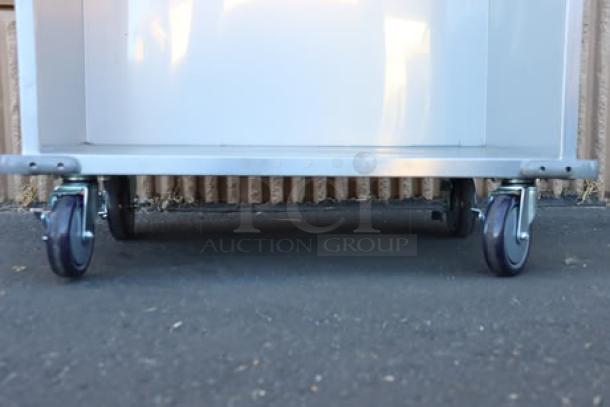 ServIt 32" stainless steel flatware/tray cart model TSC-32, 8 pan capacity, minor scratches and dents, wheels shown.