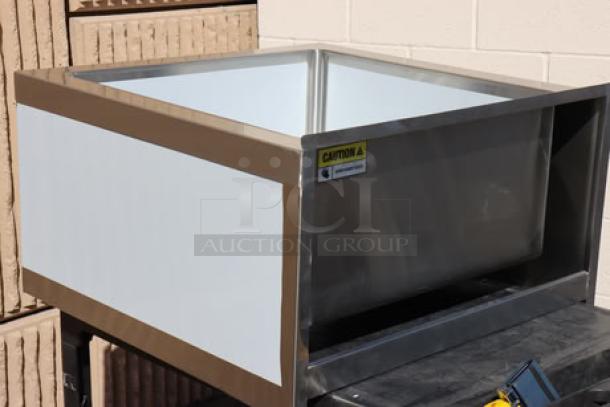 Regency stainless steel mop sink, model 600SM242412, 29" 16-gauge, minor denting/scratching, caution label visible.