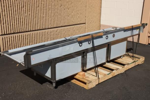 Regency 124" stainless steel three-compartment sink with two drainboards, model 600S32424218. New, bent back right leg socket.