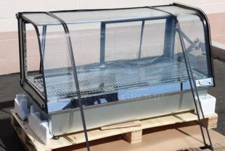 Brand new Avantco BCDI-48 curved refrigerated bakery display case, black frame, 48", 115V, on pallet, minor dents.