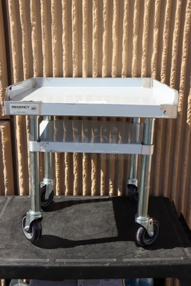 Regency 600ES2424GK 24" x 24" stainless steel equipment stand with galvanized undershelf and casters, minor scratches.