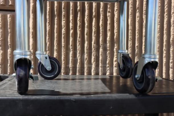 Regency 600ES2424GK stainless steel stand with galvanized undershelf and casters, minor scratches, out of packaging.